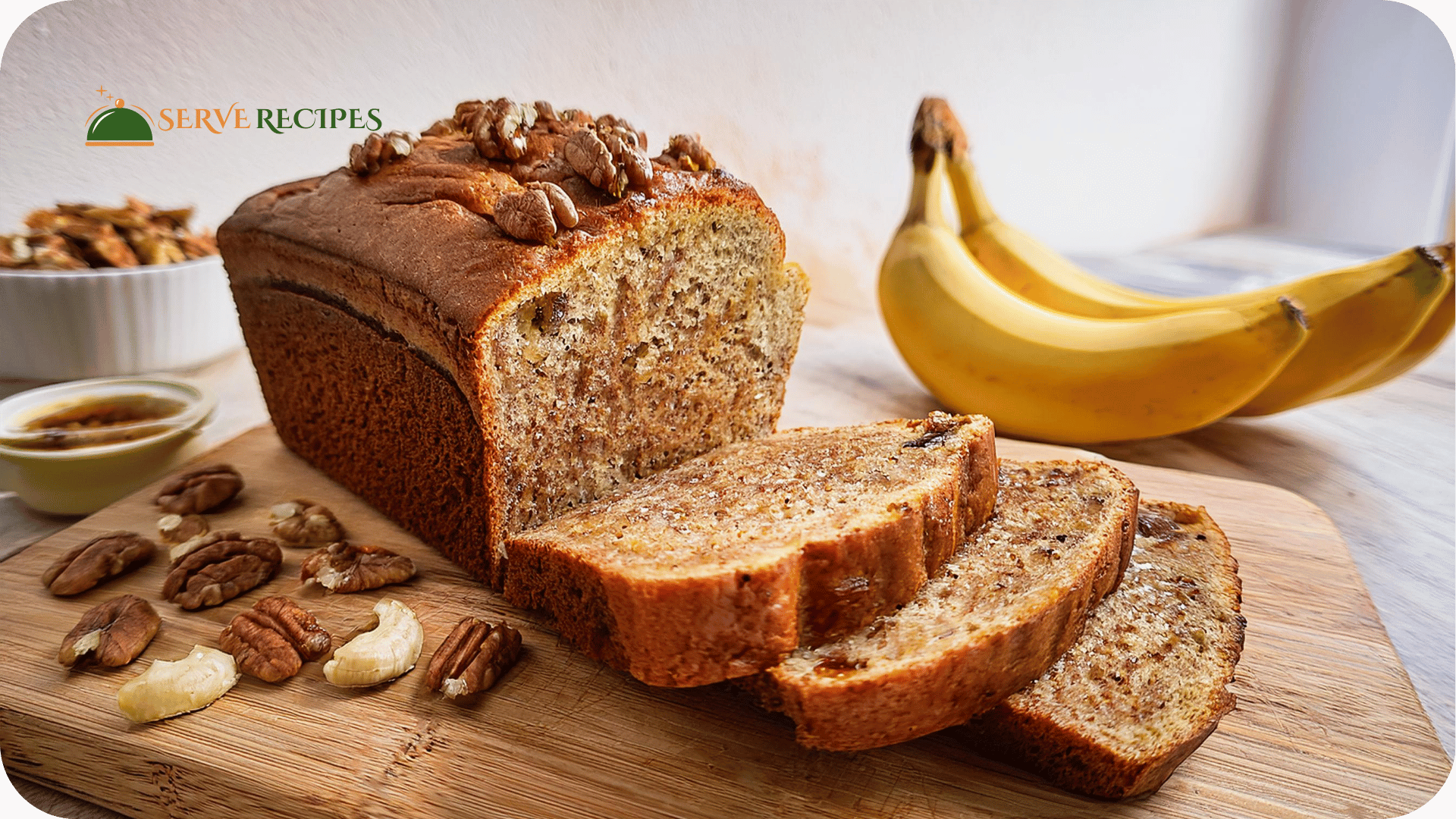 Freshly baked banana nut bread with slices showing moist texture and chunks of walnuts, placed on a wooden board.